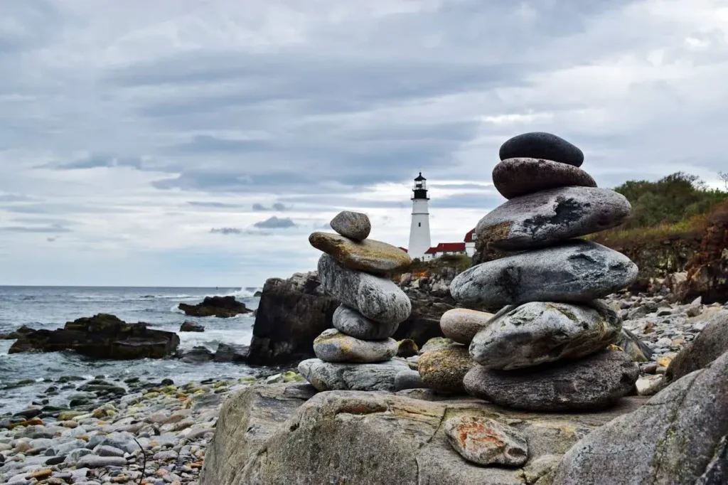 Cairns in front of a lighthouse